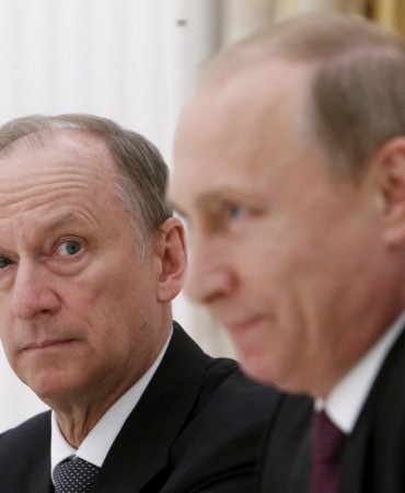 FILE PHOTO: Russian Security Council Secretary Nikolai Patrushev (L) looks at President Vladimir Putin during a meeting with the BRICS countries' senior officials in charge of security matters at the Kremlin in Moscow